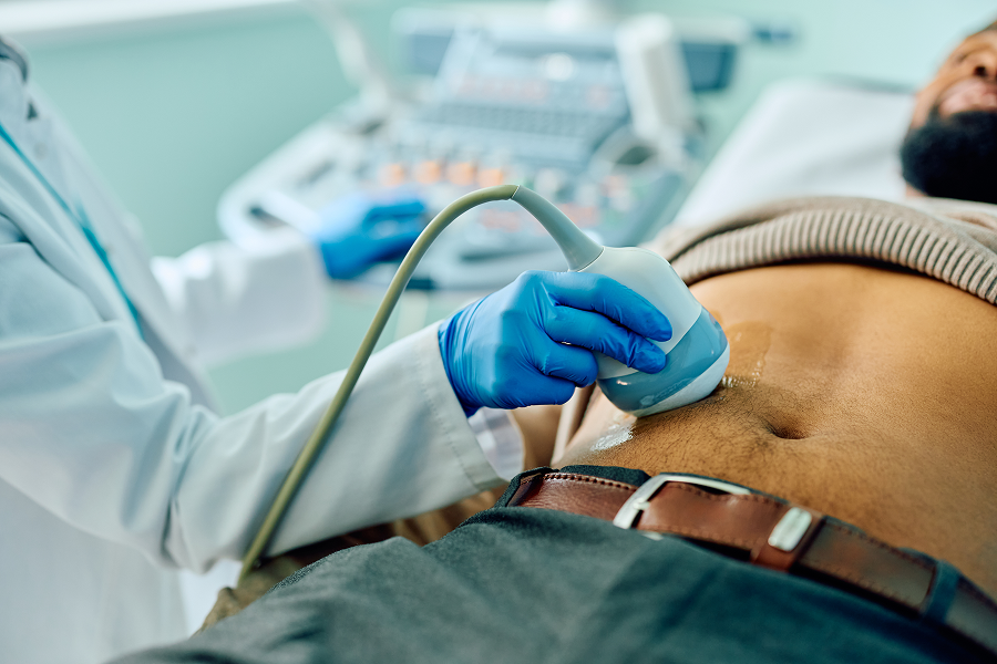 Doctor performing abdominal ultrasound