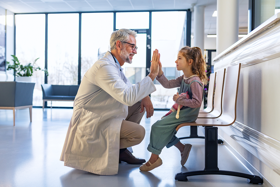Pediatrician congratulates young patient