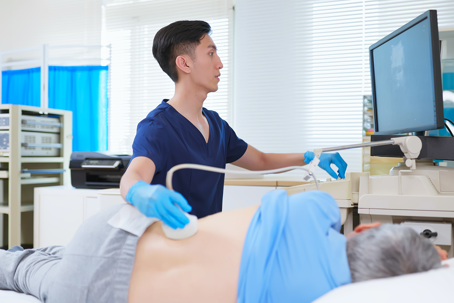 Doctor performing ultrasound on patient's back