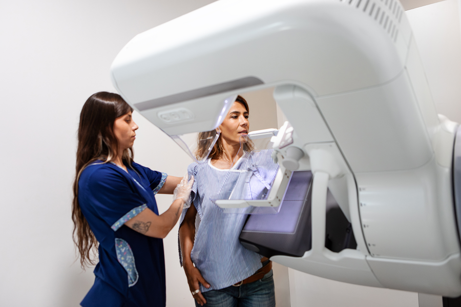 Medical professional operating breast screening equipment