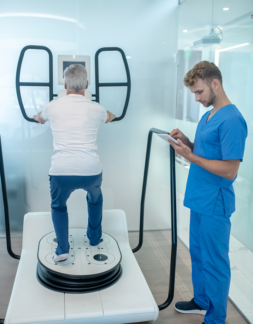 Elderly man using balance machine