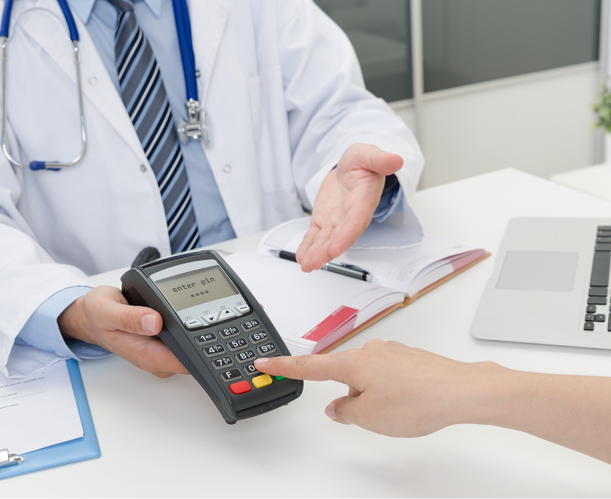 Doctor presenting payment terminal to patient