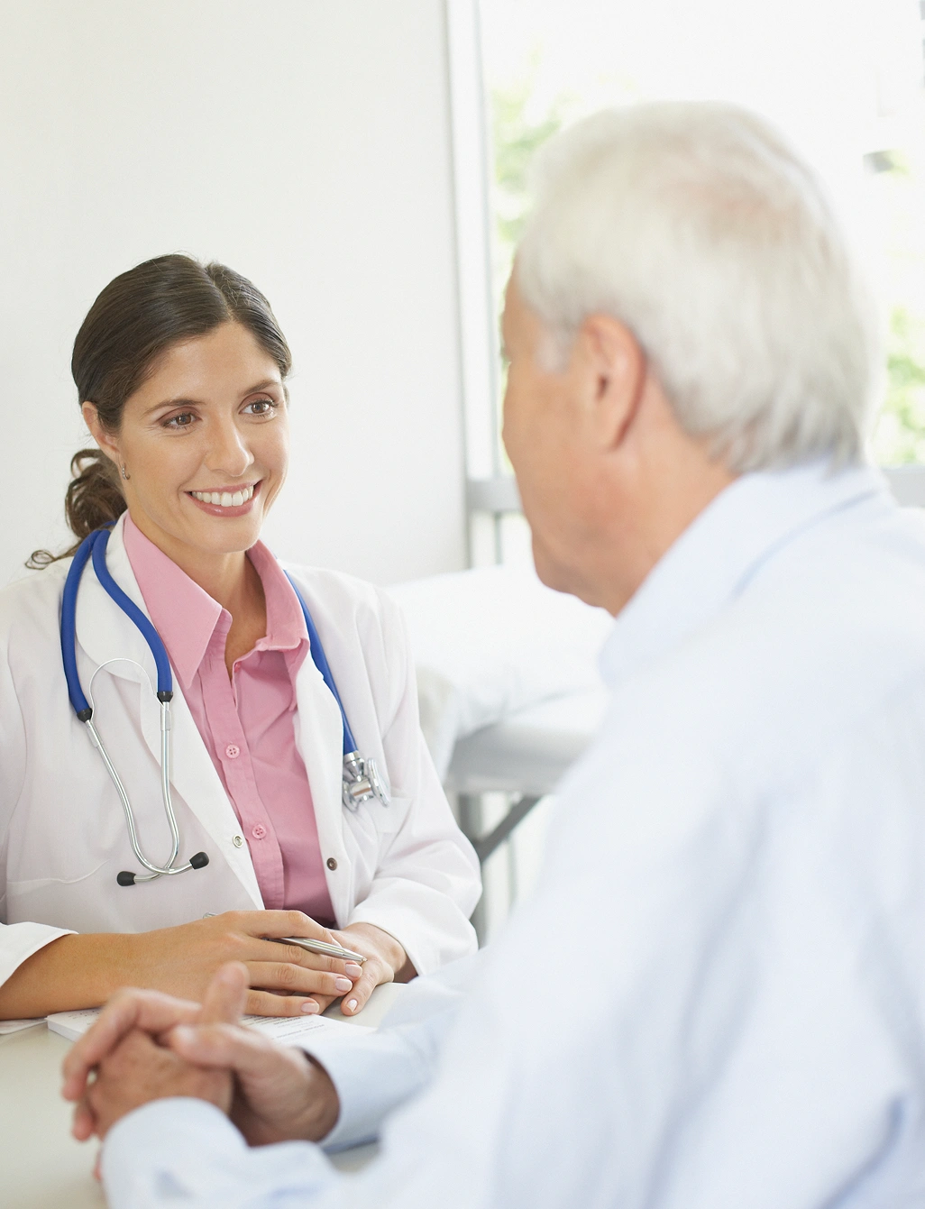 Healthcare professional meeting with senior man