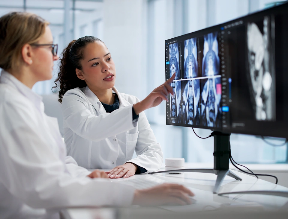 Doctors examining MRI scans on computer